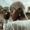 Model wearing zig zag earrings and ring